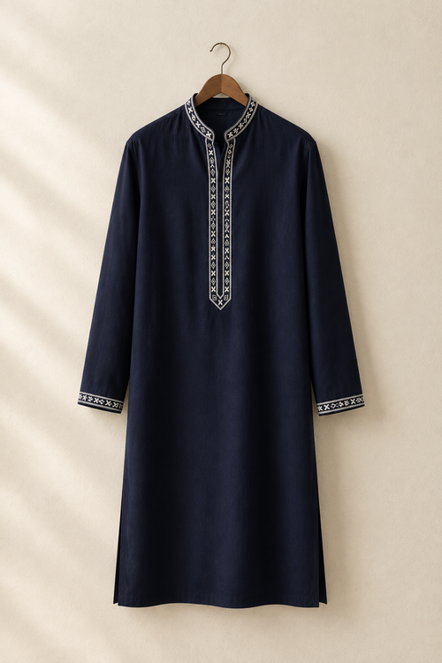 Deep navy embroidered kurta hanging on a wooden hanger against a warm studio wall