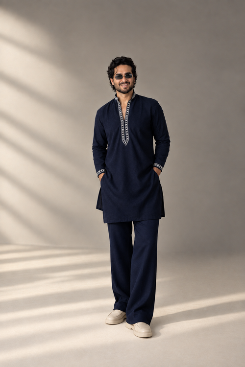Model wearing the navy embroidered kurta with matching navy-blue pants, styled with a relaxed elegant fall